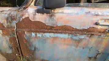 Old car or vintage car Which has peeling color and has cracked color due to the sun and rain.