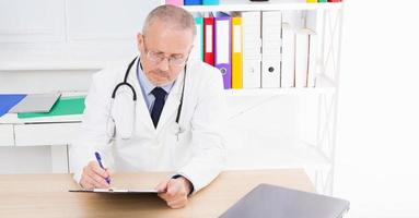 doctor works at the table in the medical office checks the results of tests photo