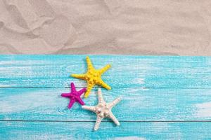 Sand copy space. Sand background top view. starfish on wooden background photo
