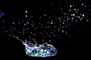 Scattered water splashes on a black background. water splash isolated on the black background photo