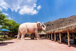 Nakhon Ratchasima, Thailand, 2021- Beautiful white elephant statue with blue sky background. Symbolize power, strength and brave at Dhama Park Anachak Luang Pu Thuat Khao Yai in Pak Chong photo