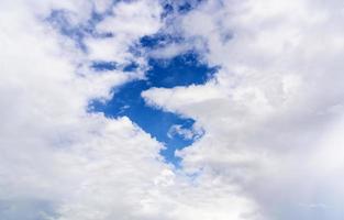 Beautiful sky background and wallpaper of white and gray clouds in the blue sky, soft focus, selective focus on blurred white clouds, and copy space for text. Concept of clouds raining and storm. photo