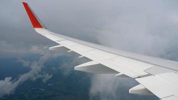 Wing of airplane on sky and cloud on moving video