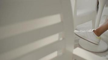 Close up of feet of schoolgirl. African american girl wearing white sneakers with socks. video