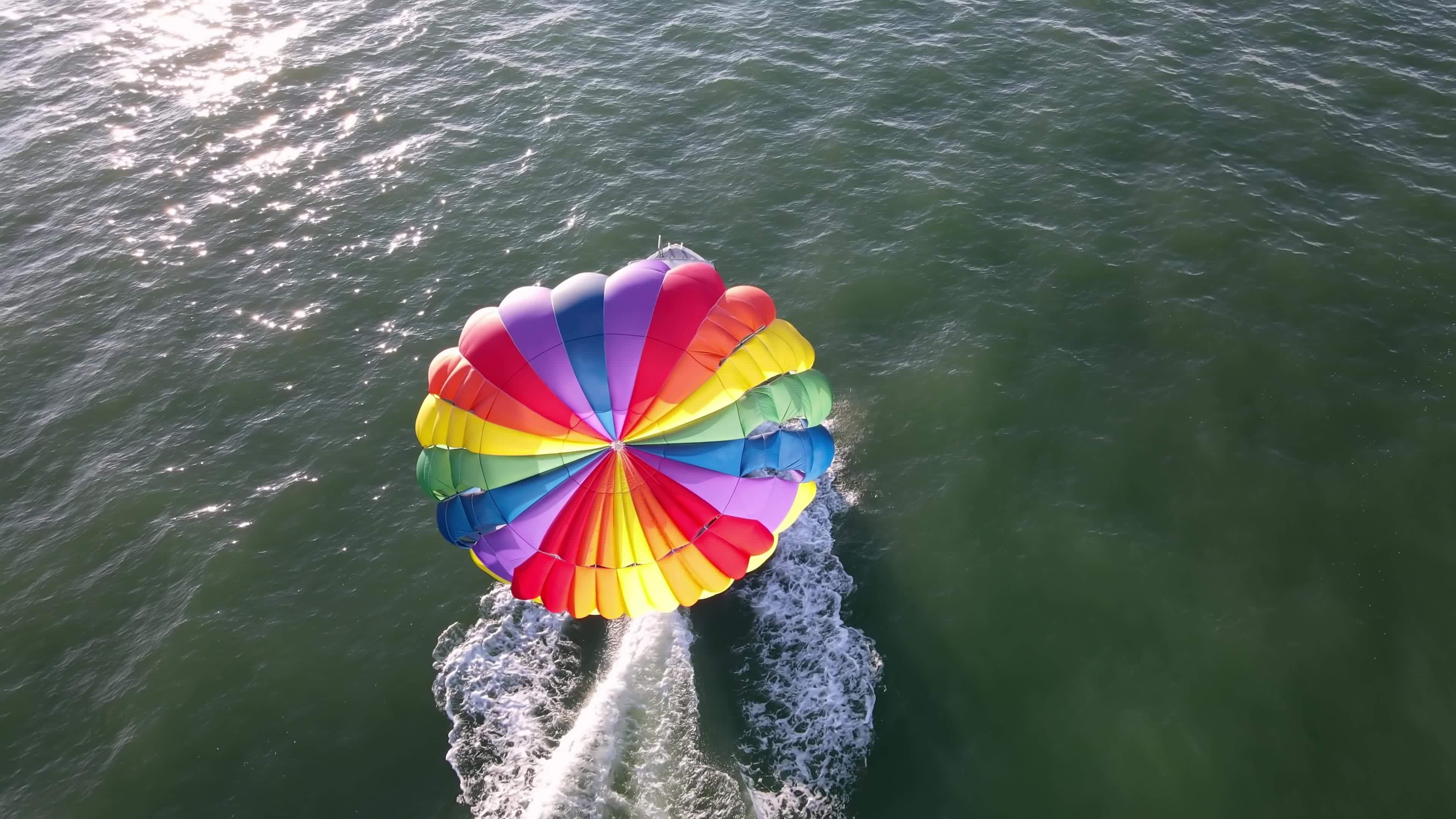Aerial view boat tow paragliding 7658469 Stock Video at Vecteezy