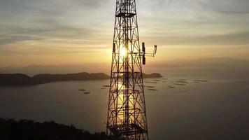 Silhouette telecommunication tower in sunset hour video