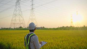 lectrical engineers report an inspection of high voltage poles before starting a project.