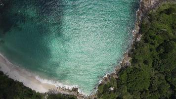 Aerial view of white sand beach and water surface texture. Foamy waves with sky. Beautiful tropical beach. Amazing sandy coastline with white sea waves. Nature, seascape and summer concept. video