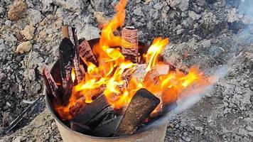 Burning wood in a metal tank close-up video