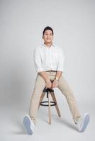 man sitting on the chair in studio photo