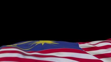 Malaysia fabric flag waving on the wind loop. Malaysian embroidery stiched cloth banner swaying on the breeze. Half-filled black background. Place for text. 20 seconds loop. 4k video