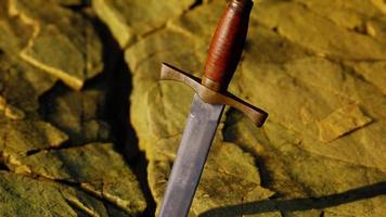 Excalibur sword in rocky stone at sunset video