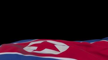 Nordkorea-Stofffahne weht auf der Windschleife. Nordkoreanische Stickerei genähtes Stoffbanner, das im Wind schwankt. halb gefüllter schwarzer Hintergrund. Platz für Texte. 20 Sekunden Schleife. 4k video