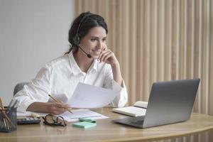 Hispanic female teacher tutor giving online lesson via internet, using laptop computer photo