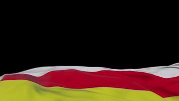 North Ossetia fabric flag waving on the wind loop. North Ossetia embroidery stiched cloth banner swaying on the breeze. Half-filled black background. Place for text. 20 seconds loop. 4k video