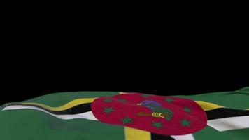 Dominica fabric flag waving on the wind loop. Dominica embroidery stiched cloth banner swaying on the breeze. Half-filled black background. Place for text. 20 seconds loop. 4k video