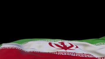 Irans tygflagga vajar på vindslingan. iran broderi sticked tyg banner vajande på vinden. halvfylld svart bakgrund. plats för text. 20 sekunders loop. 4k video