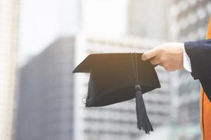 A photograph of a man with a hat after graduation photo