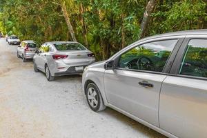 Tulum Quintana Roo Mexico 2022 Entrance to caribbean coast beach with parked cars Tulum Mexico. photo