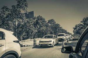 Tulum Quintana Roo Mexico 2022 Typical colorful street road traffic cars palms of Tulum Mexico. photo