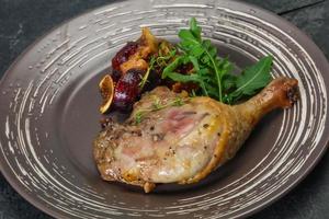 Roasted. duck. leg with plum and apple photo