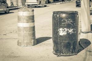 Black trash garbage cans dirty street Playa del Carmen Mexico. photo