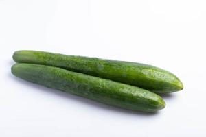 Two Japanese cucumbers on a white background