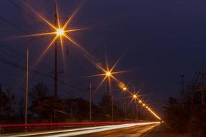 Lighting from lamps and headlights on rural roads. photo