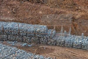 Stone in the mesh prevents erosion. photo