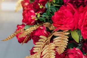 Golden pine leaves with red flowers. photo