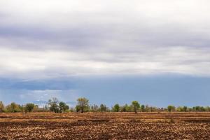 Cloudy views over arid rice fields. photo