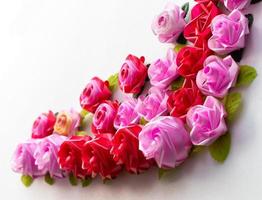 Artificial pink roses red on a white background. photo