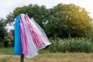 Colorful plastic bag with blurred trees. photo