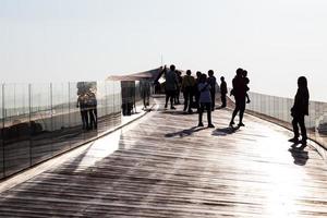 Silhouette people on the old wooden boat bridge. photo