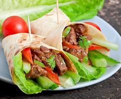Tortilla wraps with meat and fresh vegetables photo