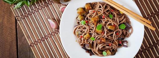 Soba noodles with eggplant in sweet and sour sauce photo