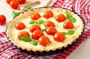 Tart with tomato and cheese with basil photo