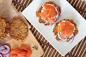 Buckwheat pancakes with salted salmon and sour cream close up