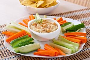 Healthy homemade  hummus with olive oil and pita chips photo