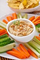 Healthy homemade  hummus with olive oil and pita chips photo