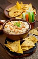 Healthy homemade  hummus with olive oil and pita chips photo