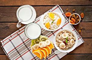 Healthy breakfast - oatmeal, cottage cheese, milk and fruit photo