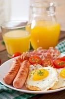 English breakfast - toast, egg, bacon and vegetables in a rustic style on wooden background photo