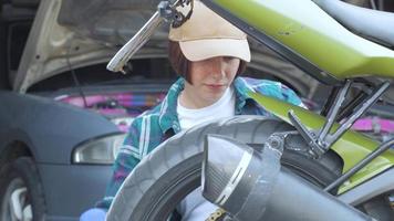 Female mechanic fixing car in a garage video