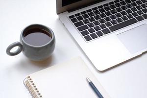 notebook on white table with gadgets and decorations, top view of writer, freelancer or buisinessman work place photo