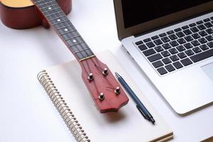 notebook on white table with gadgets and decorations, top view of writer, freelancer or buisinessman work place photo