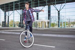 Cyclist man riding fixed gear sport retro bike. photo