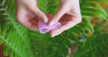 Close up of menstrual cup in woman hands. Zero waste and eco friendly concept video