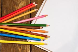 table set with colorful pencils photo