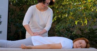 Woman do traditional chinese massage outdoors in summer garden